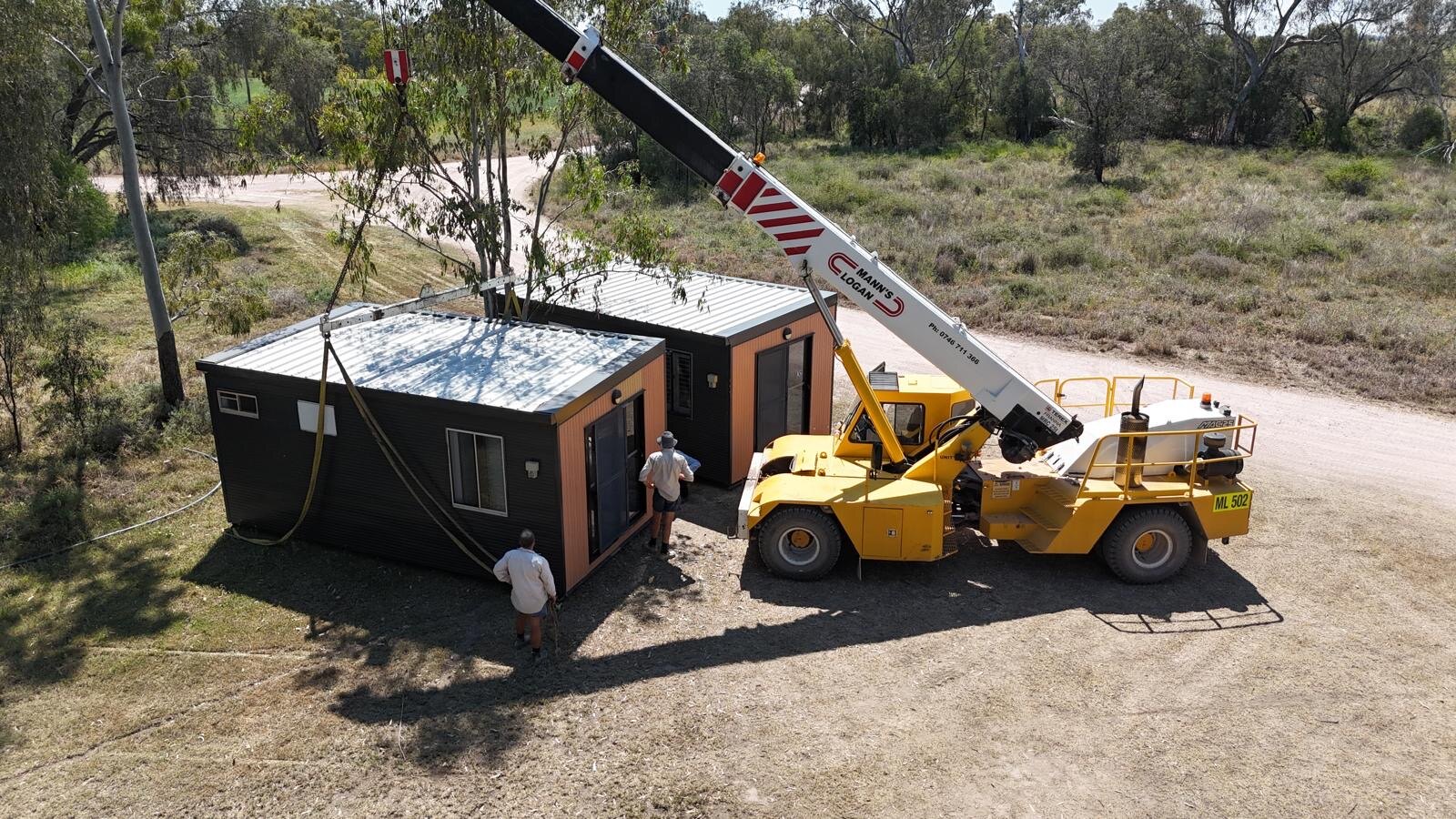 Crane installing a portable accommodation building