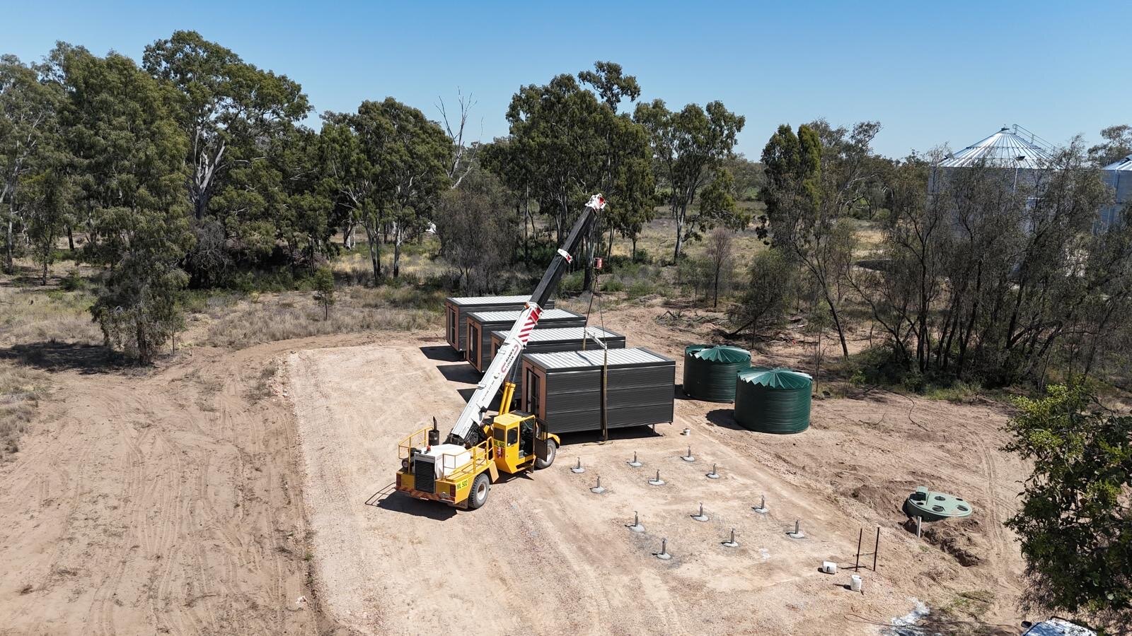 Portable accommodation buildings and water tanks on site