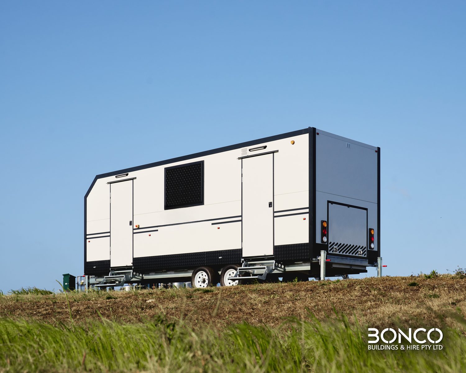 Bonco mobile crib room hire – dual-axle crib room trailer with two doors and a screened window, three-quarter view